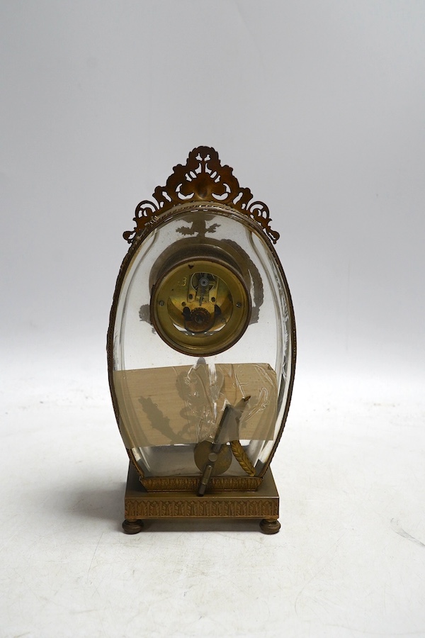 A French decorative oval shaped glass and gilt mounted mantel clock, 23cm high. Condition - good, unchecked if working